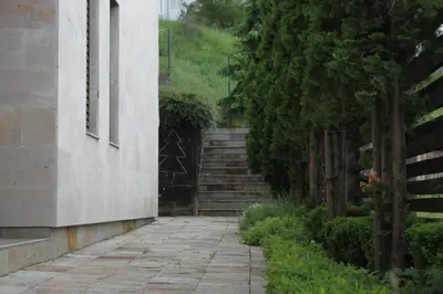 a stone walkway next to a building with stairs at The Stone Villa in Beli Iskar