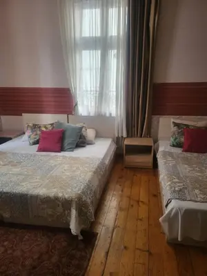 a bedroom with two beds and a window at Hostel Alex 1 in Sofia