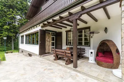 an outdoor patio with a bench and a pergola at Villa Kalia in Borovets