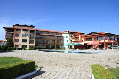 a large building with a swimming pool in front of it at Hotel Grand in Samokov