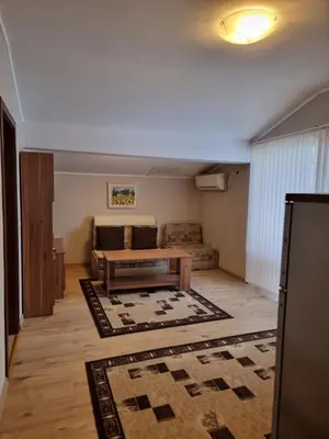 a living room with a couch and a table at Andreevite Houses in Sapareva Banya