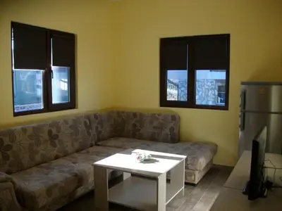 a living room with a couch and a table at Andreevite Houses in Sapareva Banya