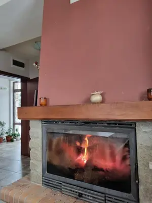 a fireplace with a fire inside of it at Andreevite Houses in Sapareva Banya