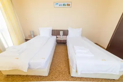 two beds sitting next to each other in a room at Ring Hotel in Blagoevgrad