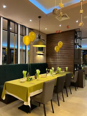 a dining room with a table and chairs and balloons at Family Hotel Ognyanovo in Ognyanovo