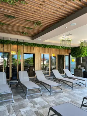 a group of chairs in a lobby with windows at Family Hotel Ognyanovo in Ognyanovo