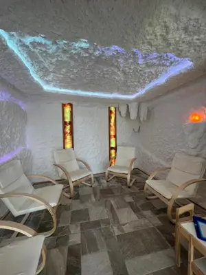 a room with white chairs and a ceiling with lights at Family Hotel Ognyanovo in Ognyanovo