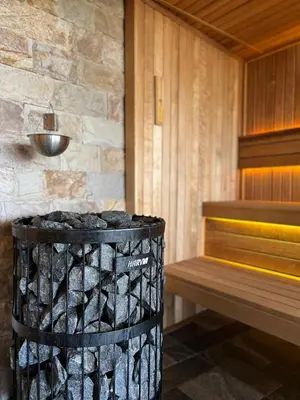 a bathroom with a trash can and a bench at Family Hotel Ognyanovo in Ognyanovo