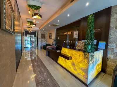a lobby of a restaurant with a counter with a plant at Family Hotel Ognyanovo in Ognyanovo