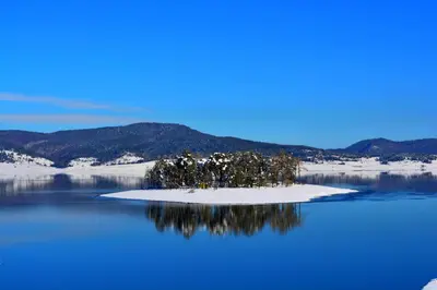 an island in the middle of a body of water at Villa Santa Maria in Tsigov Chark