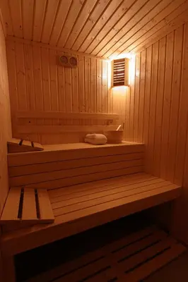 a sauna with a bench and a light in it at Family Hotel Relaxa in Sapareva Banya