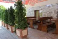 a group of potted trees in a room with a table at Family Hotel Relaxa in Sapareva Banya