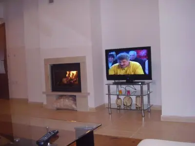 a living room with a tv and a fireplace at Grand Monastery Pamporovo Apartment 5B23 in Pamporovo