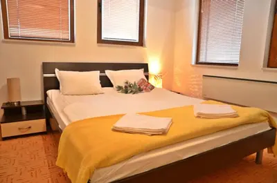 a bedroom with a large bed with two towels on it at Grand Monastery Pamporovo Apartment 5B23 in Pamporovo