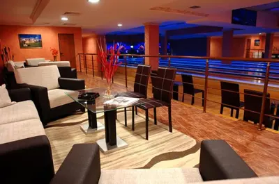 a living room with a table and chairs and a boat at Grand Monastery Pamporovo Apartment 5B23 in Pamporovo