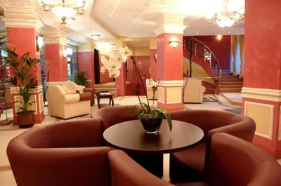 a lobby with chairs and a table with a vase of flowers at Grand Monastery Pamporovo Apartment 5B23 in Pamporovo