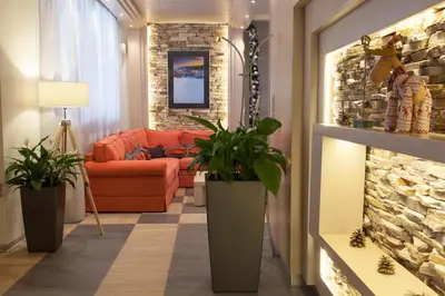 a living room with a couch and a brick wall at Amira Boutique Hotel in Bansko