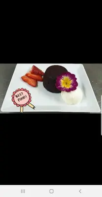 a white plate with food on a table at Family Hotel Victoria Gold in Mineralni Bani
