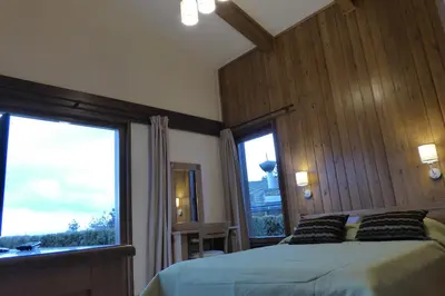 a bedroom with a bed and a large window at Pirin Nest Villa in Bansko