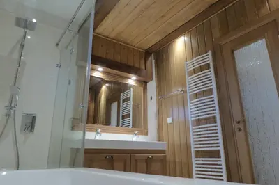 a bathroom with a tub and a sink and a mirror at Pirin Nest Villa in Bansko