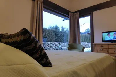 a bedroom with a bed and a large window at Pirin Nest Villa in Bansko