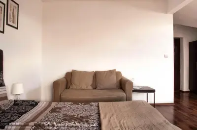 a living room with a couch and a bed at Apartment Elegant in Velingrad