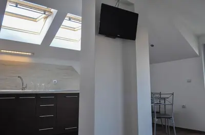 a kitchen with skylights and a tv on a wall at Apartment Elegant in Velingrad