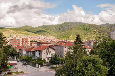 a city with houses and mountains in the background at Apartment Elegant in Velingrad