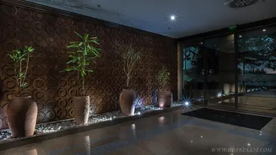 a room with potted plants on a wall at Hotel Sani in Asenovgrad