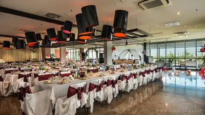 a large banquet hall with white tables and chairs at Hotel Sani in Asenovgrad
