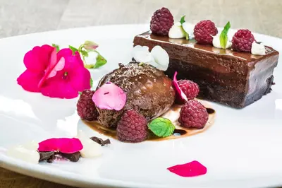 a piece of chocolate cake on a white plate at Hotel Sani in Asenovgrad