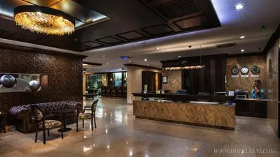 a lobby of a hotel with a bar and chairs at Hotel Sani in Asenovgrad