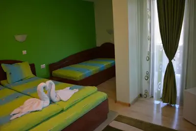 two beds in a room with two swans on them at Guest House H Dzhogolanov in Koprivshtitsa
