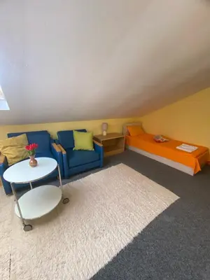 a living room with a couch and a table at Hotel Forest Star on the Ski Slope in Borovets