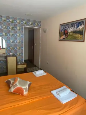 a bedroom with a bed with two towels on it at Hotel Forest Star on the Ski Slope in Borovets