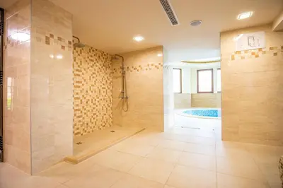 a large bathroom with a shower and a tub at Eco Hotel Momata in Kolarovo