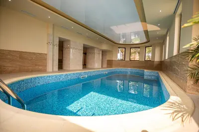 a swimming pool in the middle of a house at Eco Hotel Momata in Kolarovo