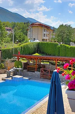 a swimming pool in front of a house at Holiday House Kubrat in Sapareva Banya