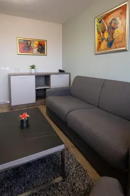 a living room with a couch and a table at La Casa Hotel in Tsigov Chark