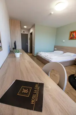 a hotel room with a table with a book on it at La Casa Hotel in Tsigov Chark