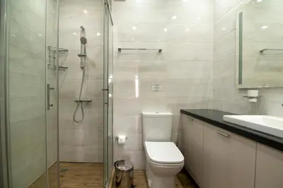 a bathroom with a shower and a toilet and a sink at La Casa Hotel in Tsigov Chark