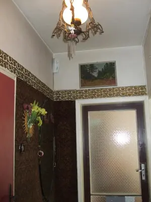 a chandelier hanging over a bathroom door with a shower at Kamigs Rooms in Sofia