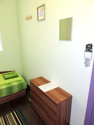 a room with a bed and a table in it at Like Home Guest Rooms in Sofia