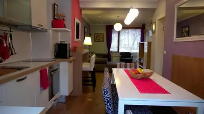 a kitchen with a table with a bowl of fruit on it at Parkview Apartments in Sofia