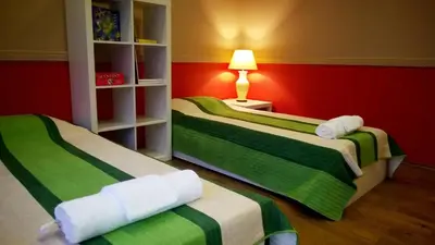 two beds in a room with red and green stripes at Parkview Apartments in Sofia