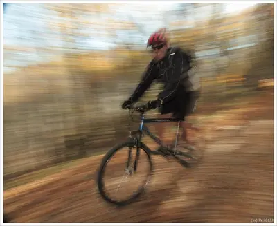 a man riding a bike down a trail at Yan BibiYan Guest House in Negushevo