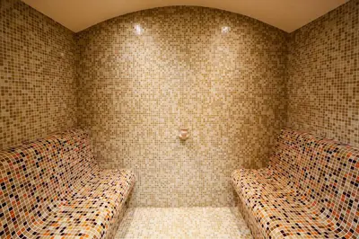 two beds in a corner of a room with tiles at Twin House in Ognyanovo