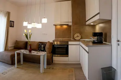 a kitchen with a couch and a table in a room at Twin House in Ognyanovo