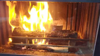 a fire in an oven with some food in it at Chepelare Holiday Guest House in Chepelare