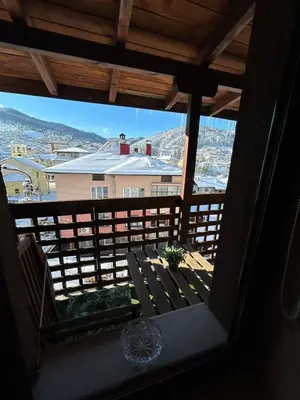 a view from the balcony of a house with a bench at Chepelare Holiday Guest House in Chepelare